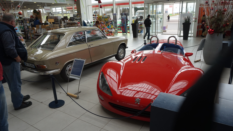 The two Peugeots on display in the gas station. 14:04